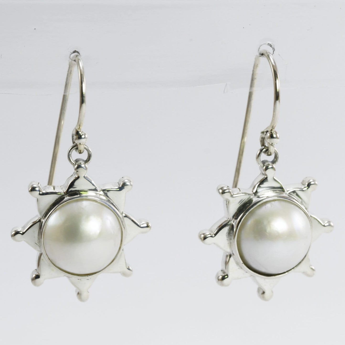 white mabe pearl earrings set in 925 sterling silver with star shape ornament