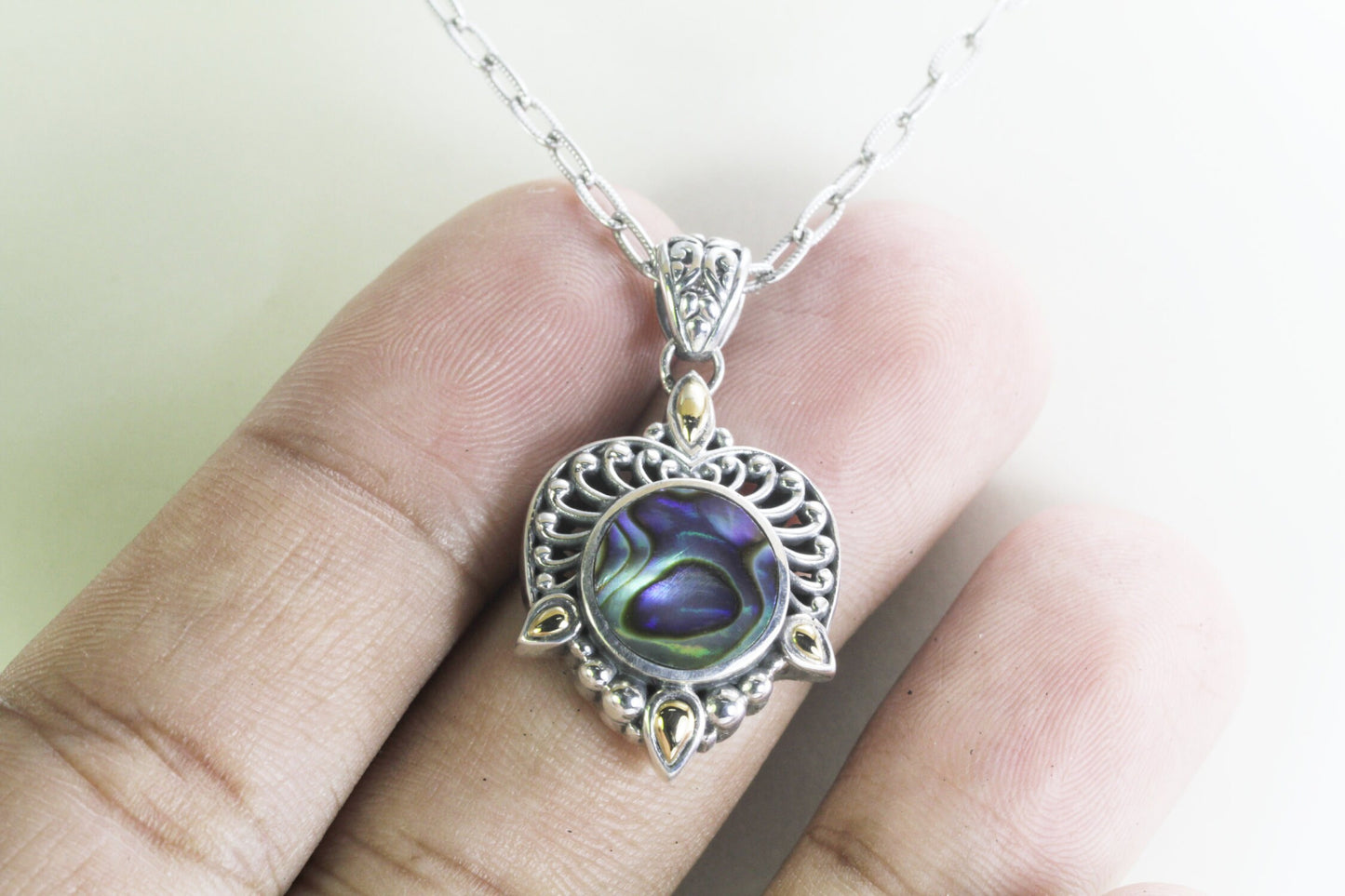 Paua shell necklace pendant set in 925 sterling silver decorated with 18K yellow gold accent and open work filigree