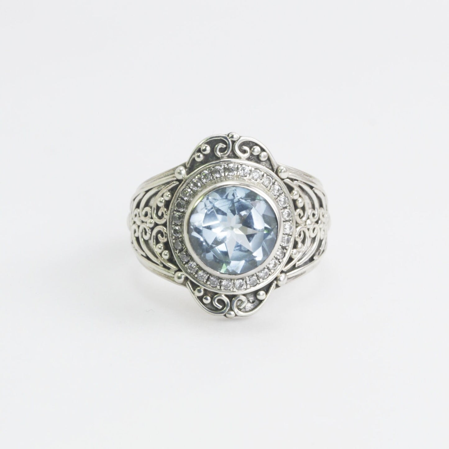 blue topaz ring set in 925 sterling silver decorated with white topaz and ornament filigree