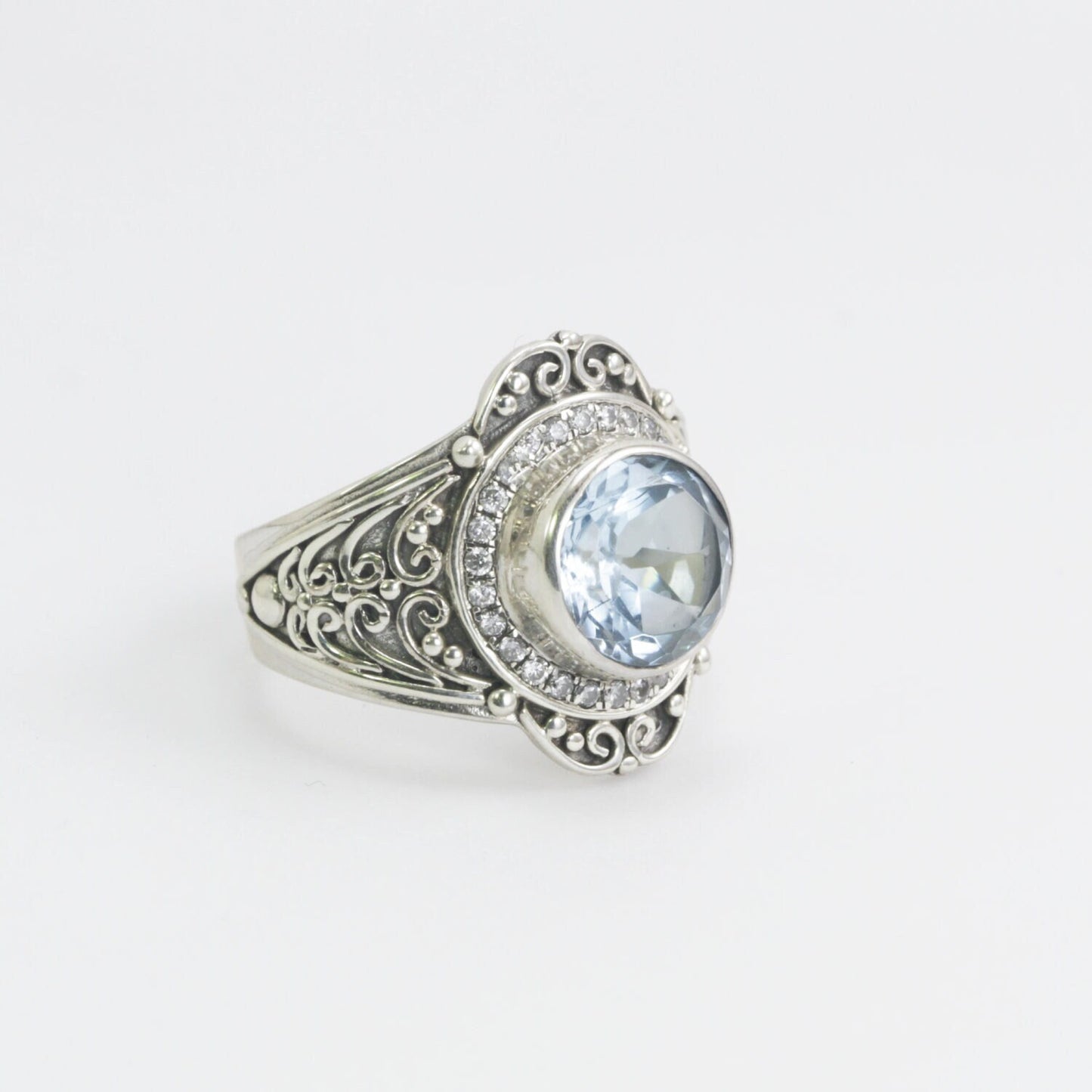 blue topaz ring set in 925 sterling silver decorated with white topaz and ornament filigree