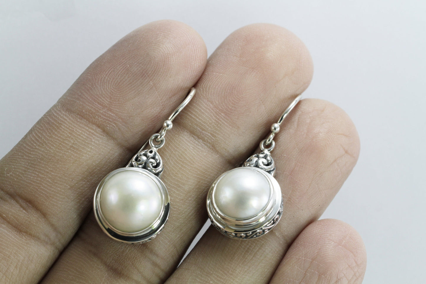 mabe pearl earrings set in 925 sterling silver decorated with filigree ornament