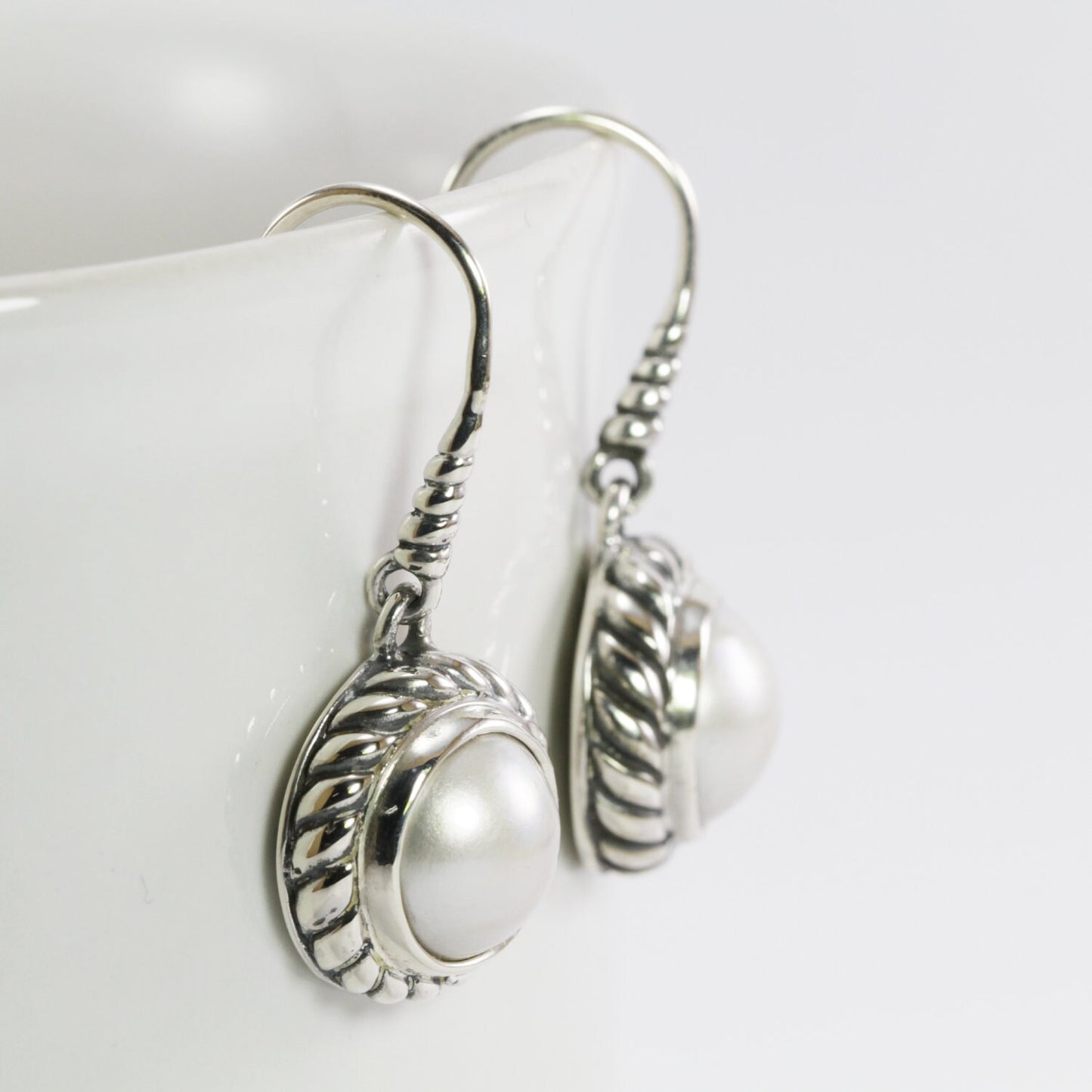 white mabe pearl earrings set in 925 sterling silver 12mm round decorated with cable ornament