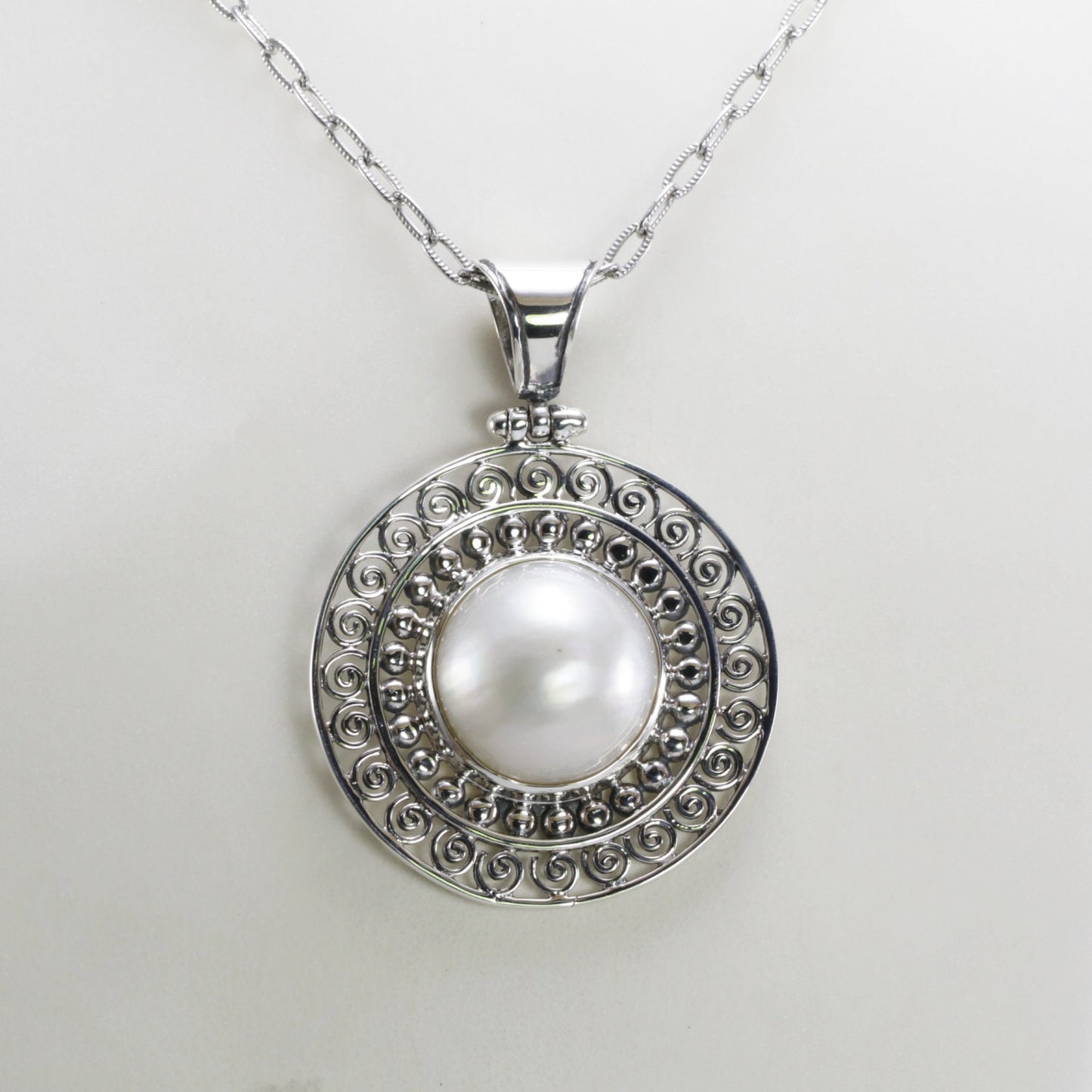 Genuine round 16 mm white Mabe pearl set in handmade 925 sterling silver pendant decorated with Bali jawan filigree
