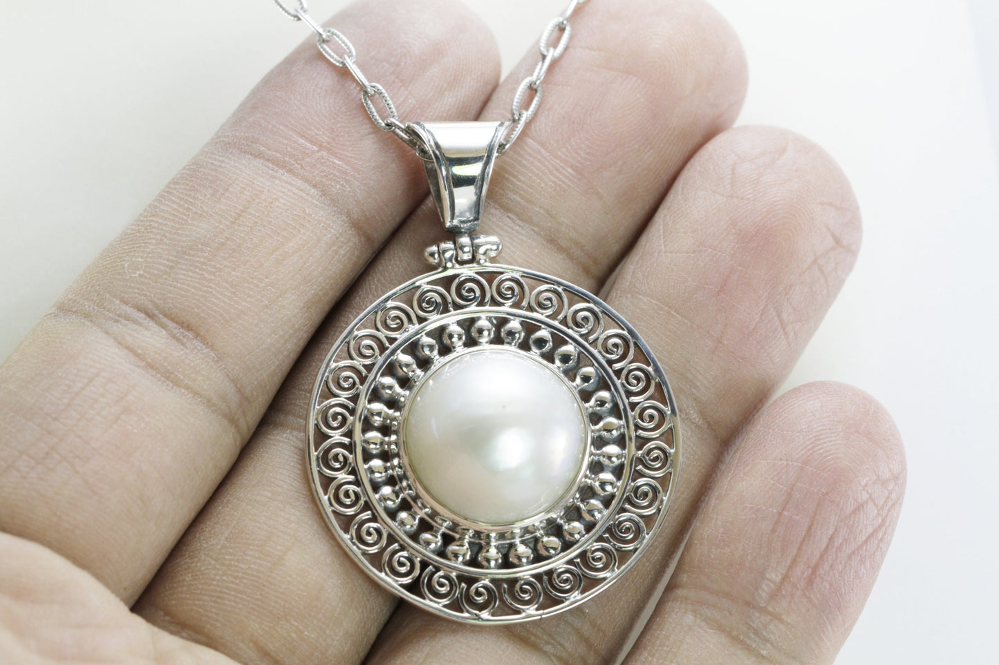 Genuine round 16 mm white Mabe pearl set in handmade 925 sterling silver pendant decorated with Bali jawan filigree