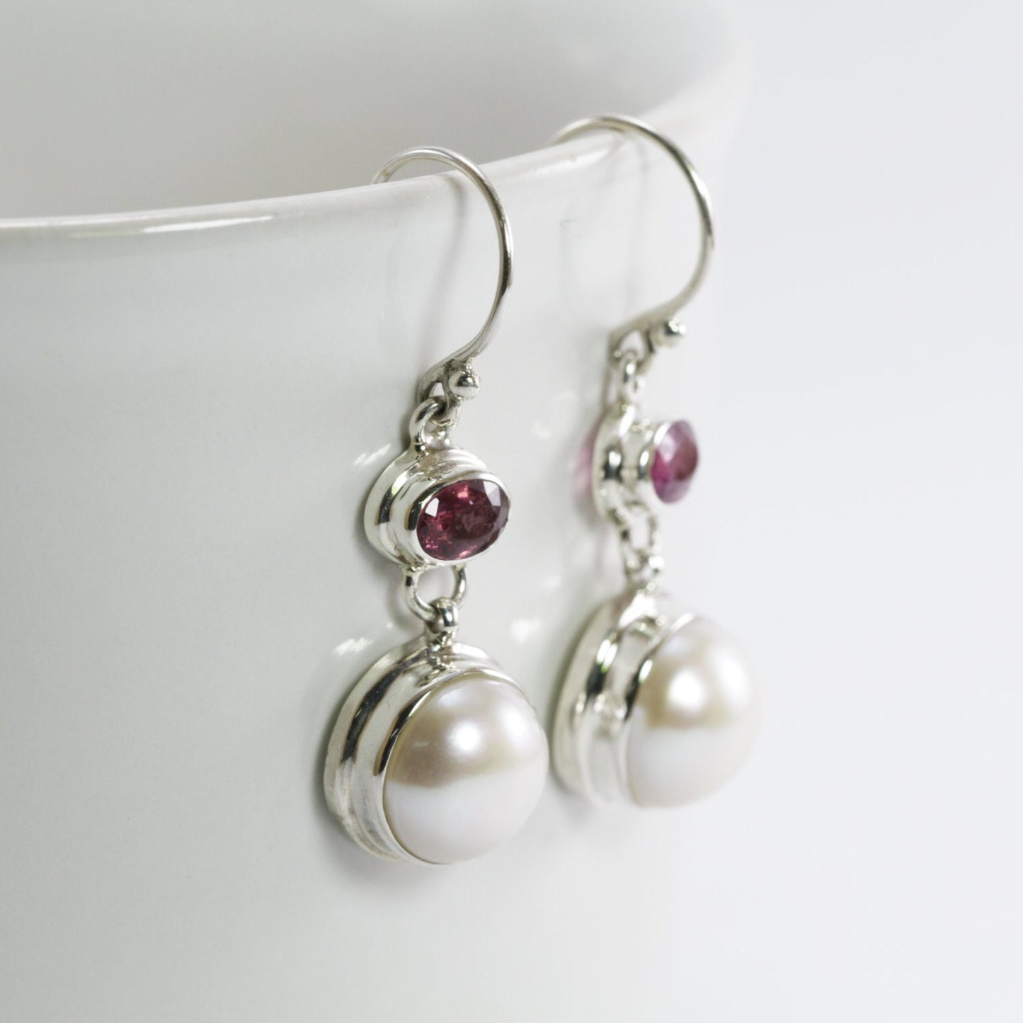 freshwater pearl earrings set in 925 sterling silver with genuine blue topaz