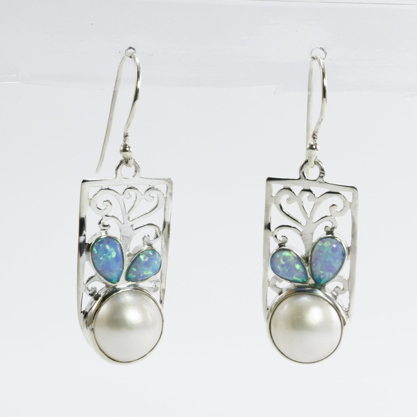 white mabe pearl earrings set in 925 sterling silver decorated with created opal and ornament filigree