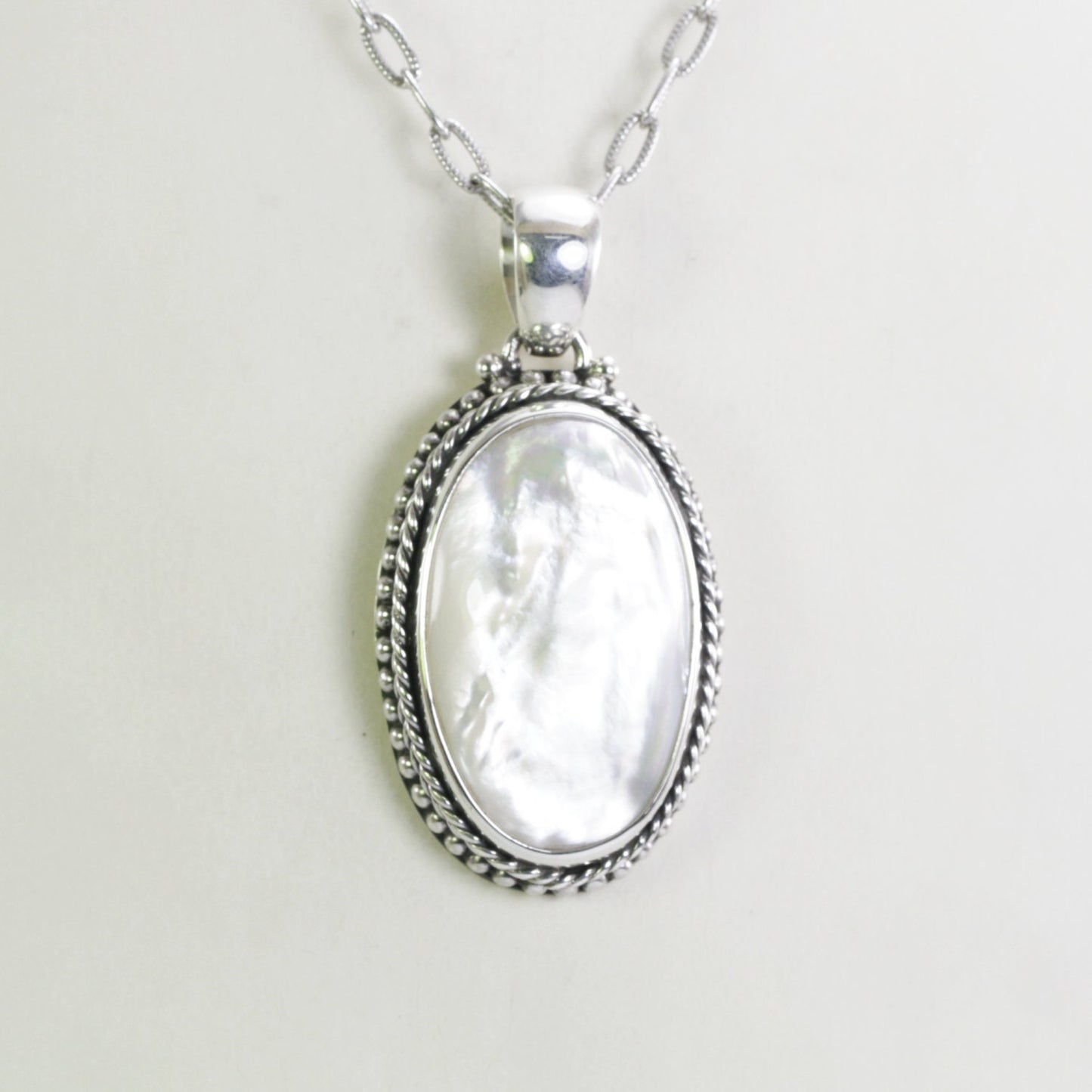 mother of pearl pendant necklace 26*16 mm width set in handmade 925 sterling silver decorated with cable and dot edge
