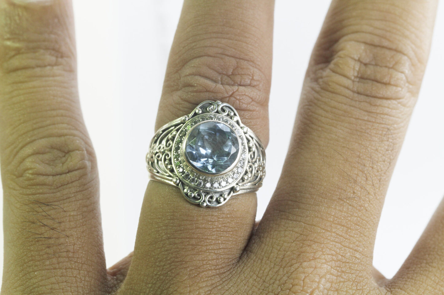 blue topaz ring set in 925 sterling silver decorated with white topaz and ornament filigree