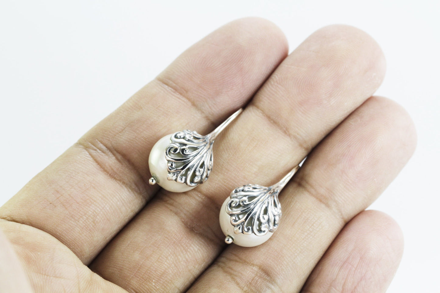 fresh water pearl earrings set in 925 sterling silver decorated with swirl filigree art