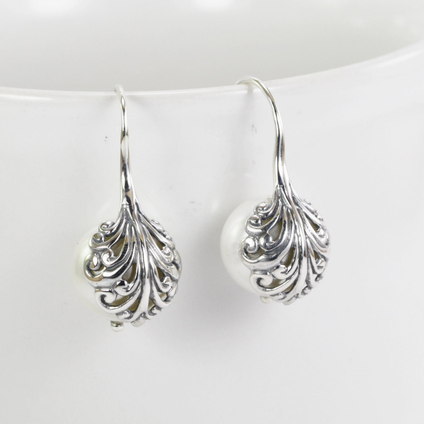 fresh water pearl earrings set in 925 sterling silver decorated with swirl filigree art