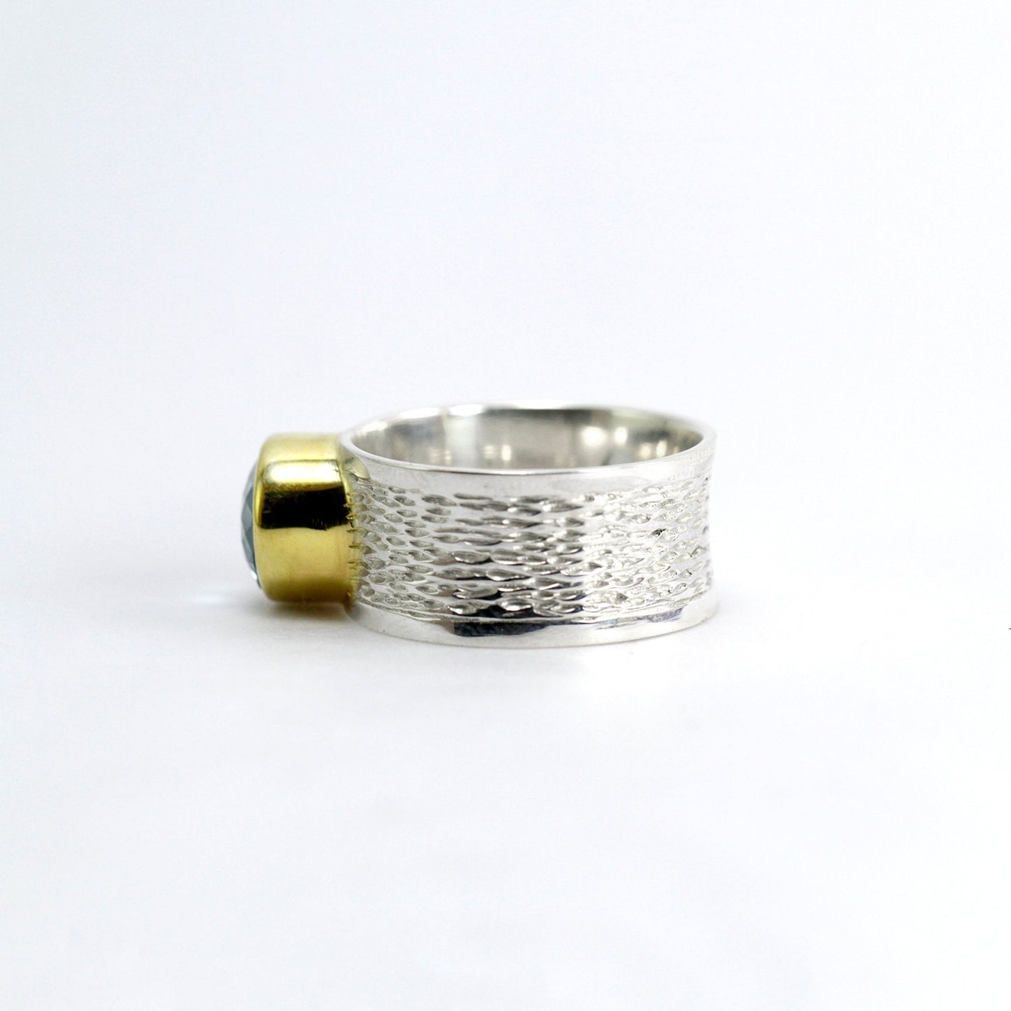 Wide band ring with genuine blue topaz decorated with gold vermeil