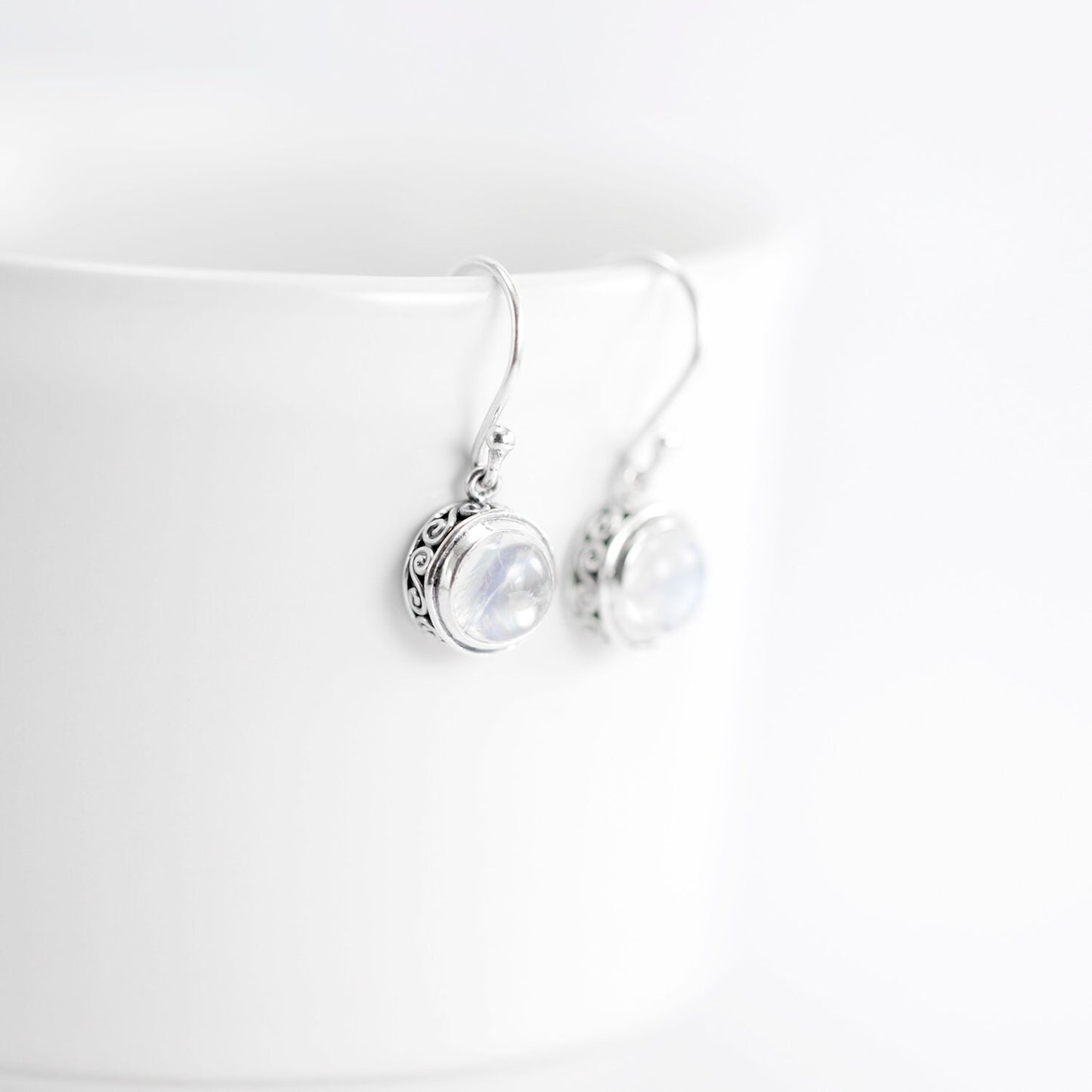 Moonstone earrings set in 925 sterling silver round dangle decorated with filigree edge