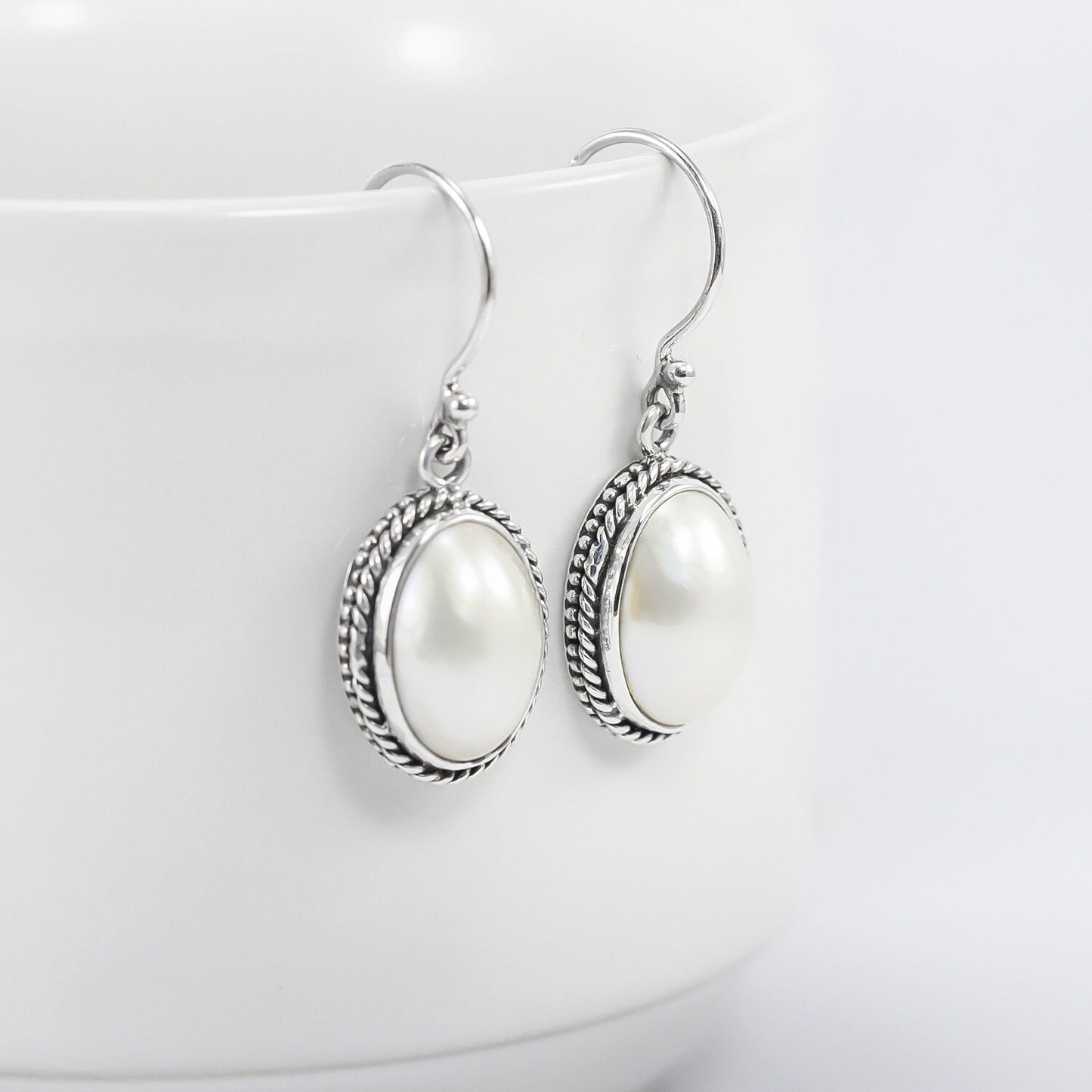 oval mabe pearl earrings 925 sterling silver decorated with woven chain edge