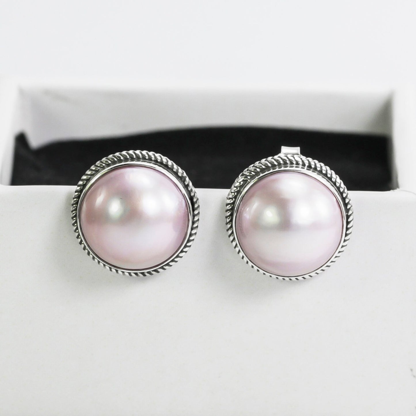 Pink mabe pearl stud earrings set in 925 sterling silver decorated with woven chain edge