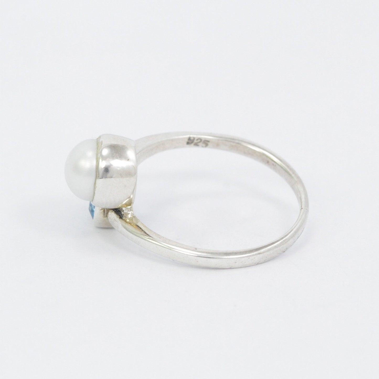 bypass ring with genuine blue topaz and freshwater pearl set in 925 sterling silver