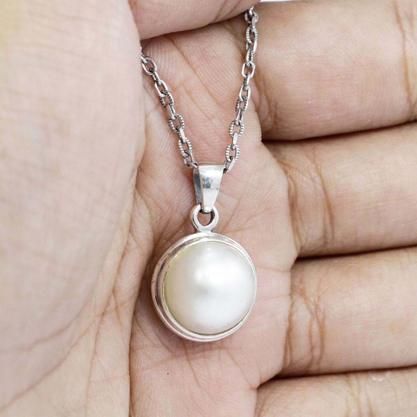 round pearl pendant 925 sterling silver bezel set decorated with open work filigree at the back side