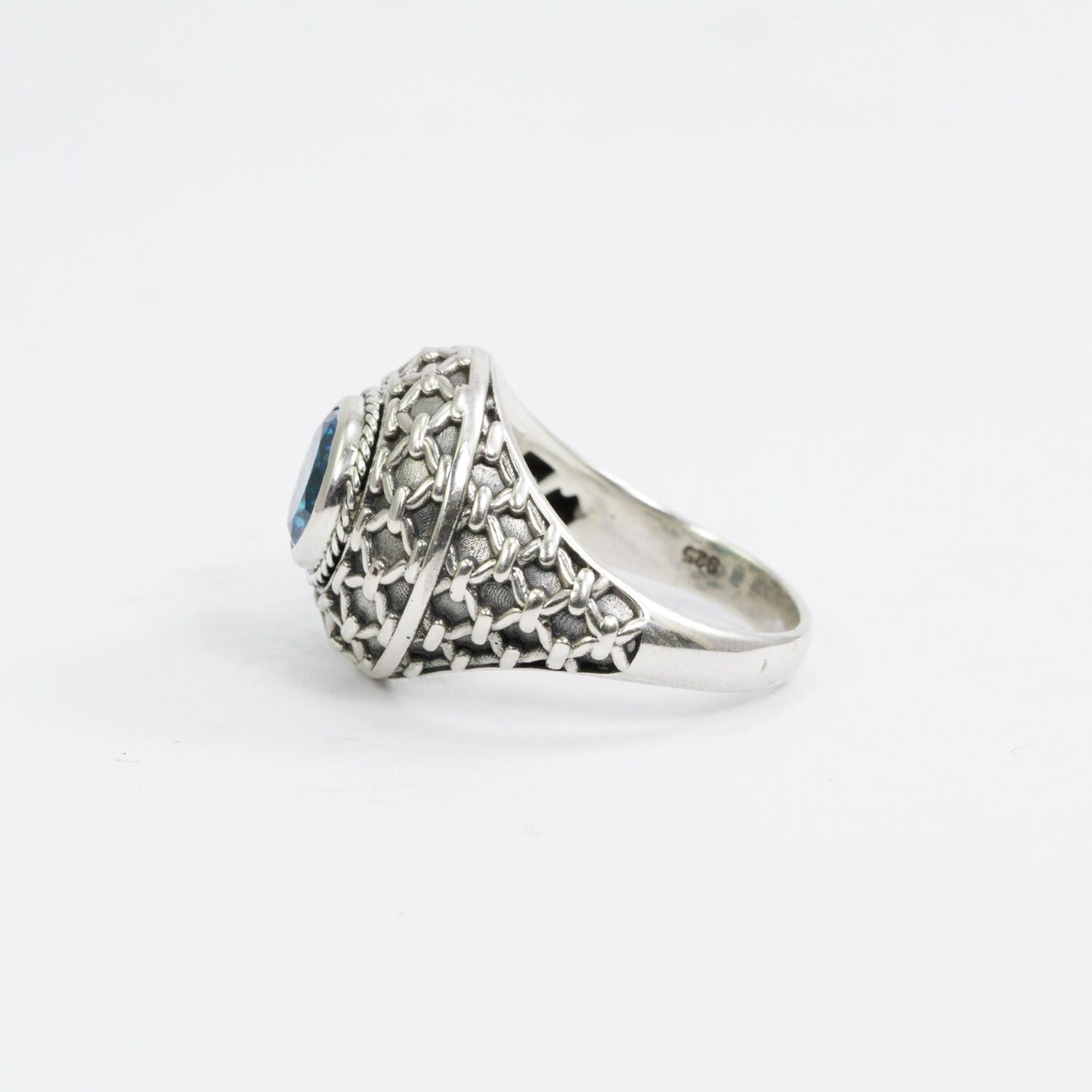 doom ring with genuine blue topaz zirconia decorated with woven web ornament