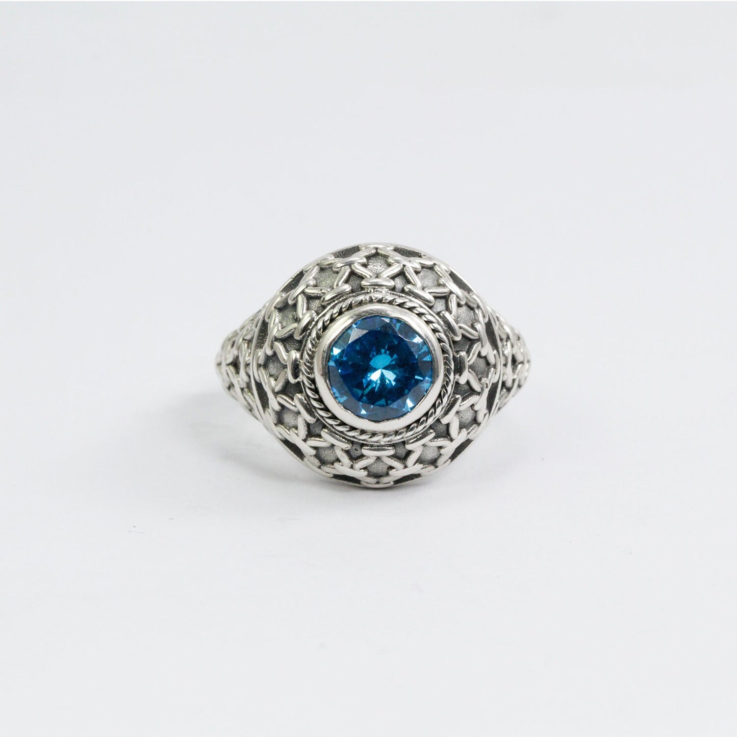 doom ring with genuine blue topaz zirconia decorated with woven web ornament