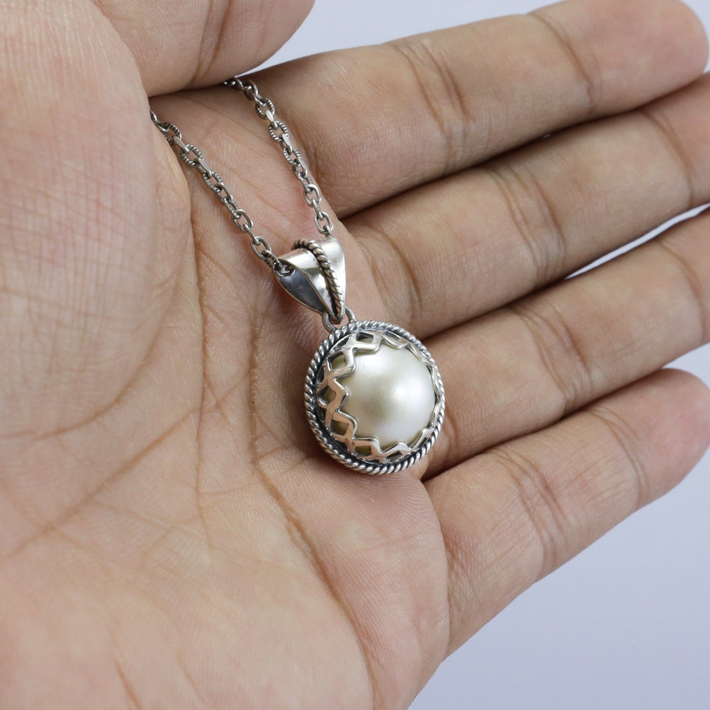 mabe pearl pendant 925 sterling silver decorated with cable ornament and woven backside