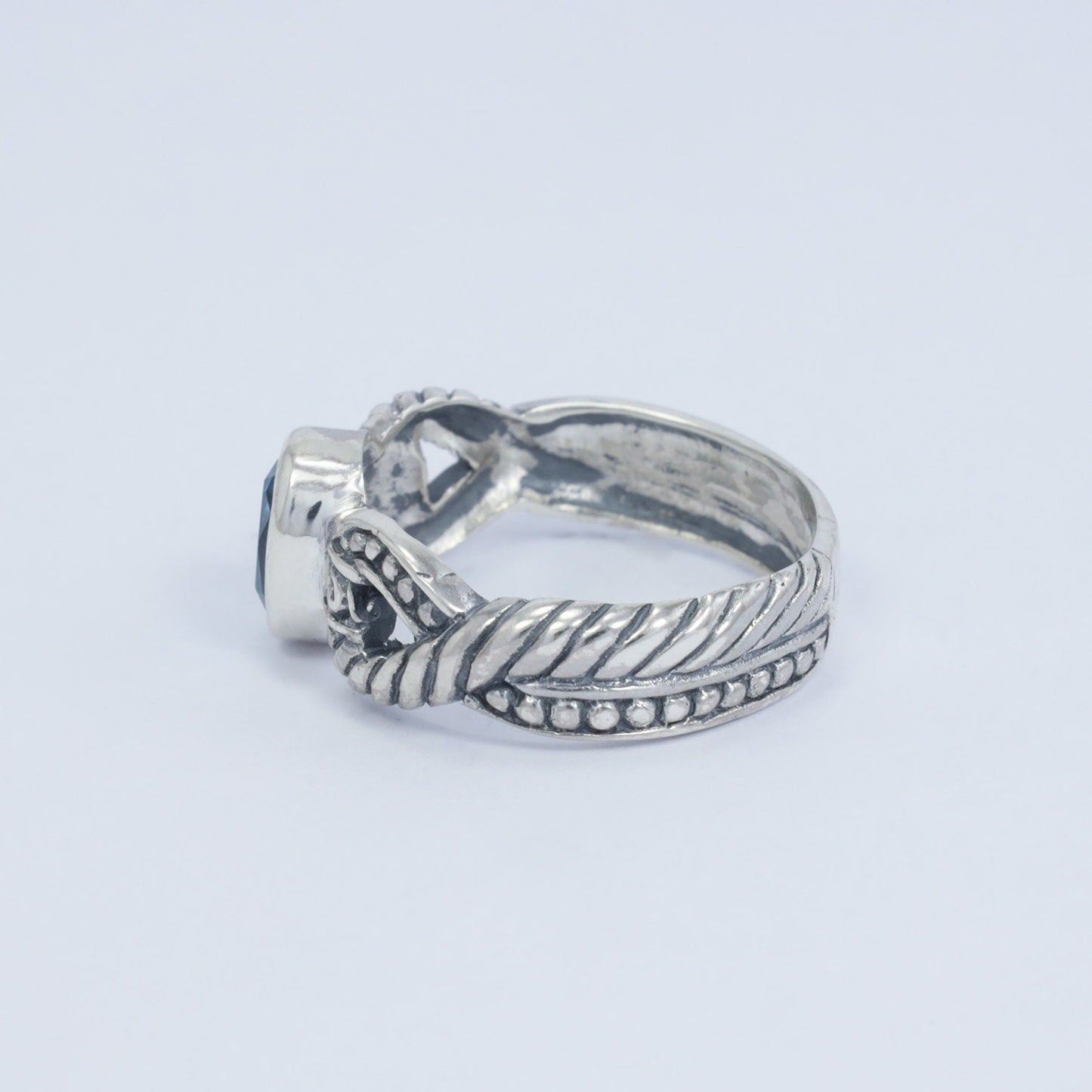 blue topaz ring set in 925 sterling silver decorated with cable ornament