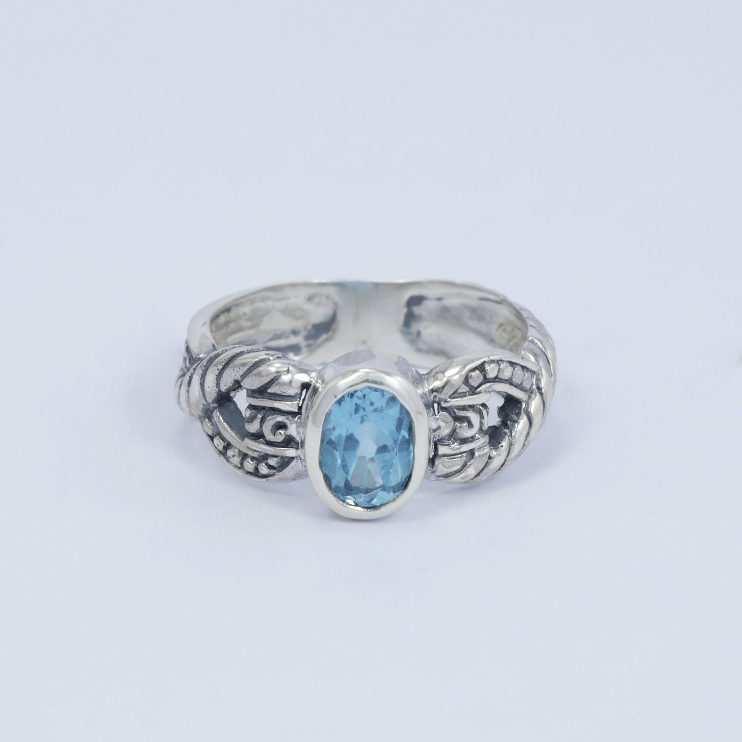 blue topaz ring set in 925 sterling silver decorated with cable ornament