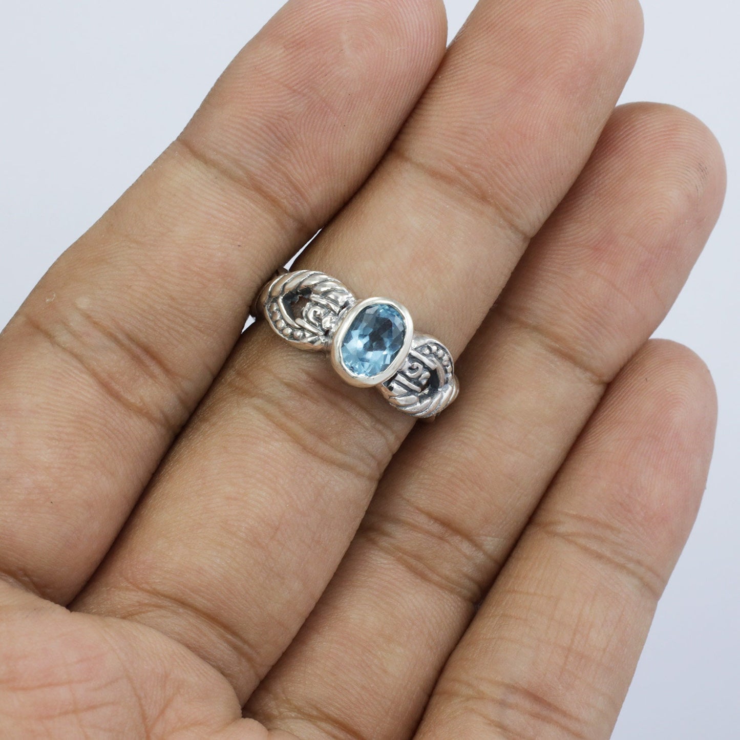 blue topaz ring set in 925 sterling silver decorated with cable ornament