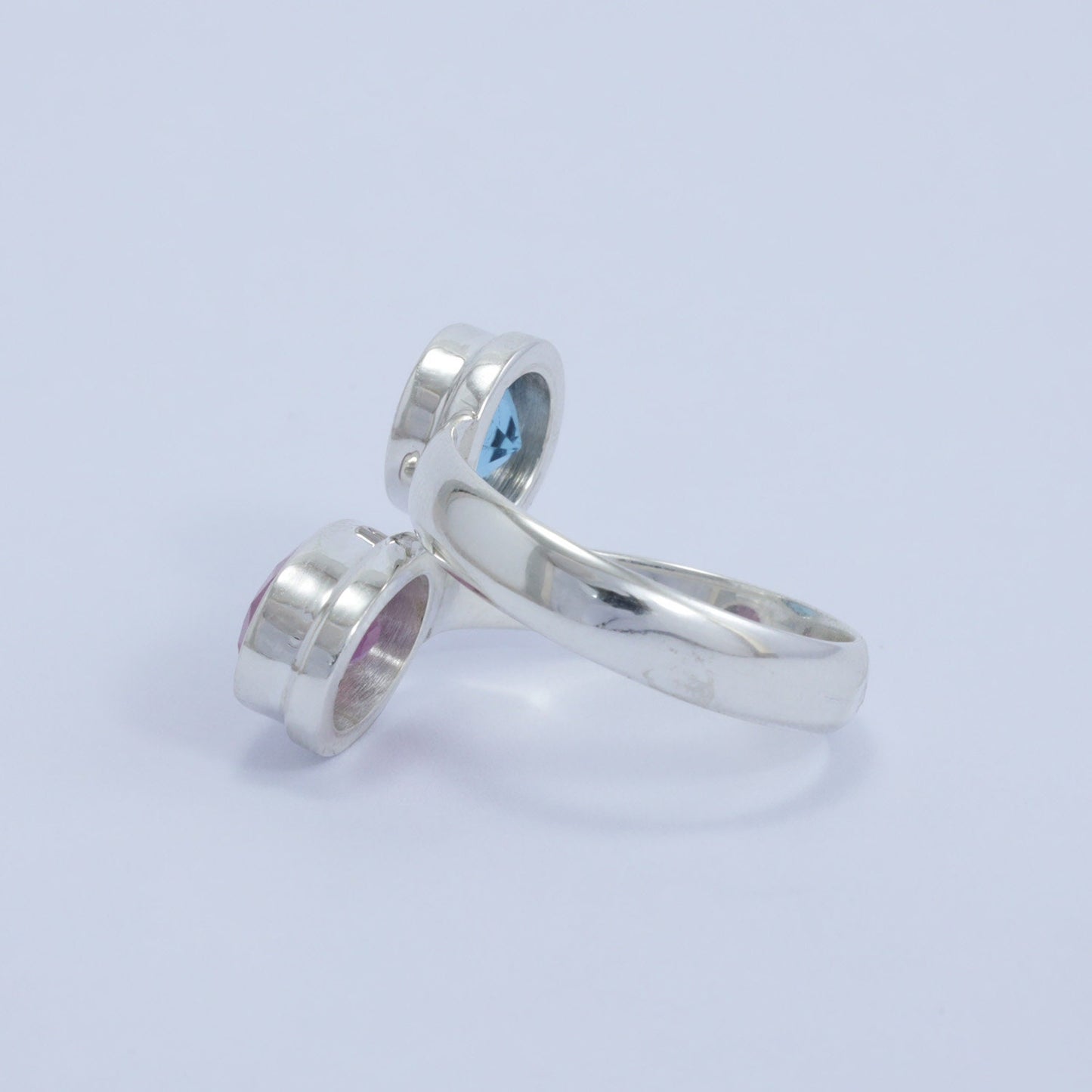 red ruby ring 925 sterling silver bypass style decorated with genuine blue topaz