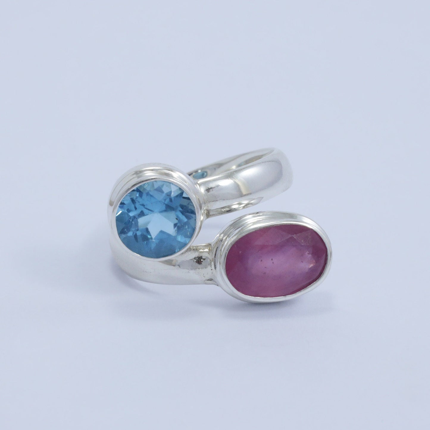 red ruby ring 925 sterling silver bypass style decorated with genuine blue topaz