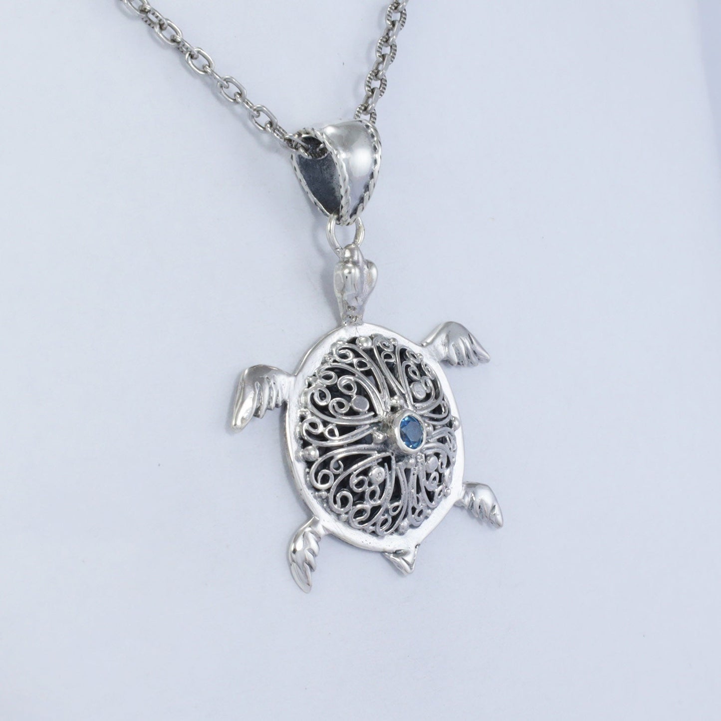 silver turtle pendant necklace decorated with openwork filigree and genuine blue topaz