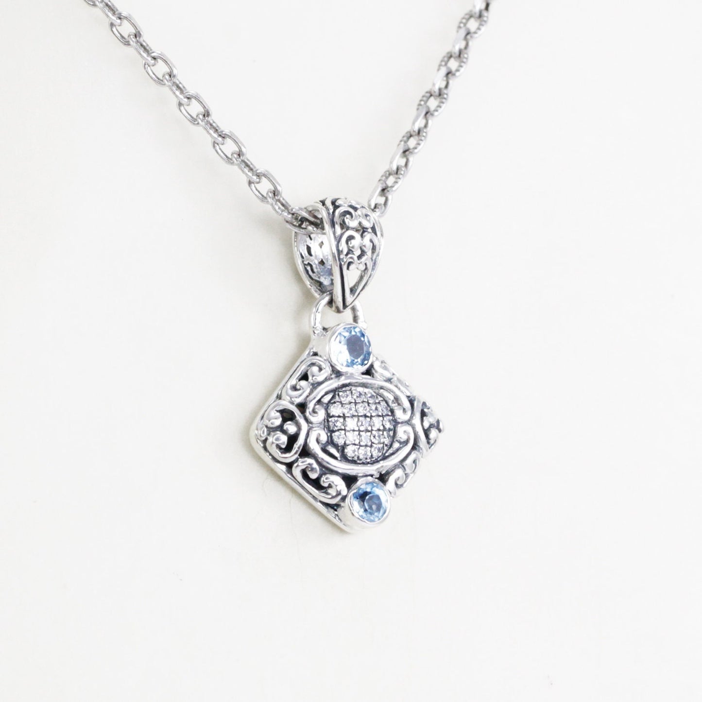 925 sterling silver pendant decorated with Bali inspired ornament and genuine blue topaz