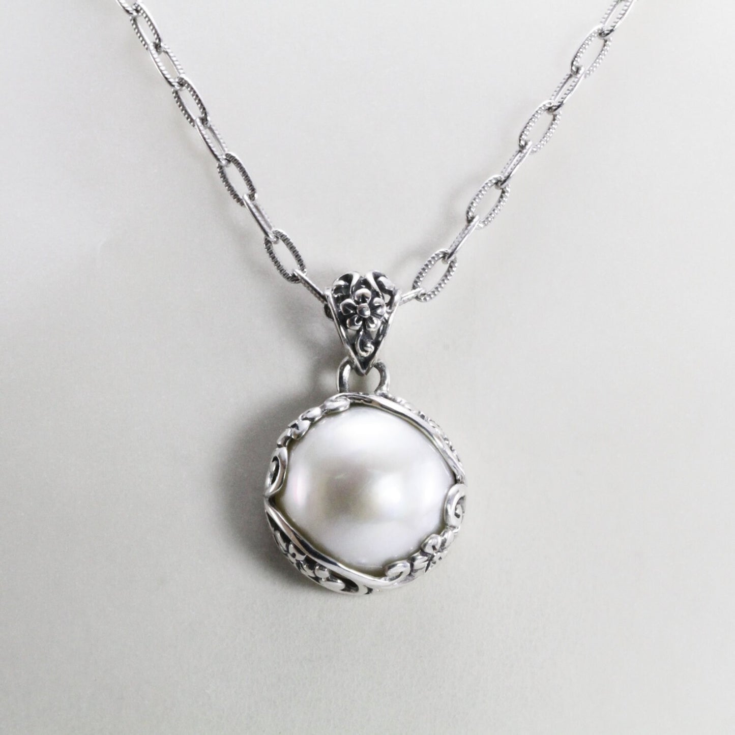 mabe pearl pendant with beautiful  floral art edge in 925 sterling silver