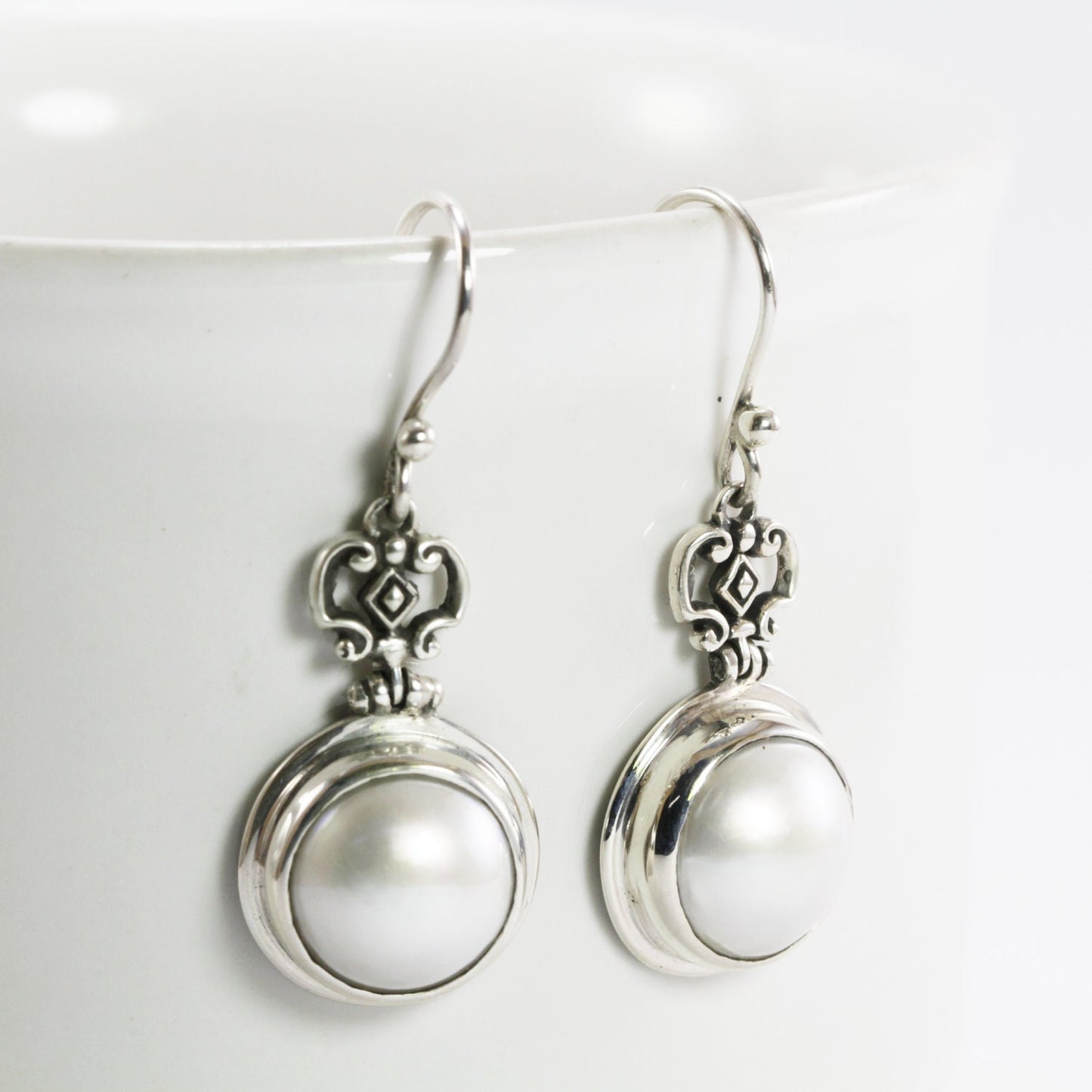 Beautiful white mabe pearl dangle drop earrings set in handmade 925 Sterling silver decorated with filigree crown