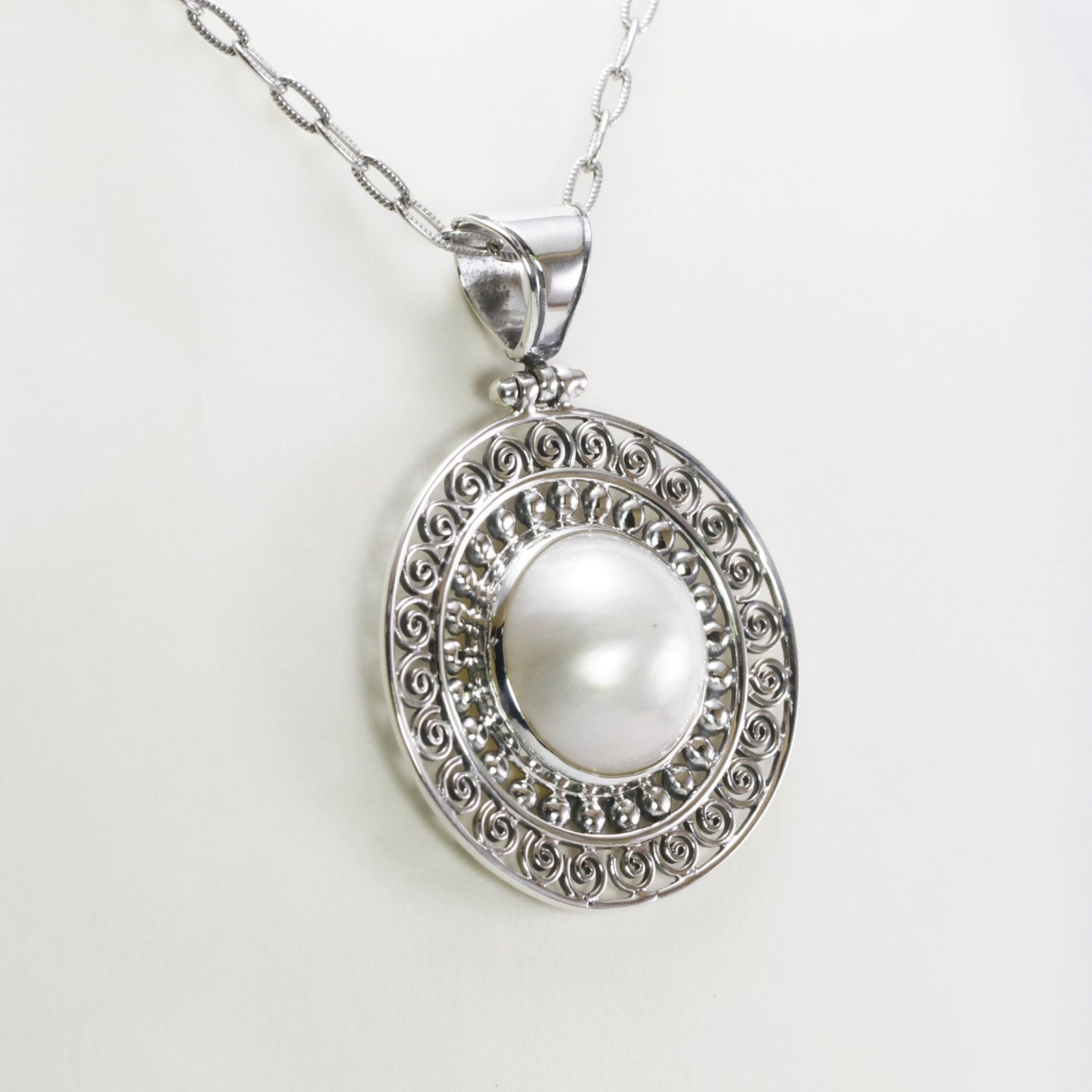 Genuine round 16 mm white Mabe pearl set in handmade 925 sterling silver pendant decorated with Bali jawan filigree