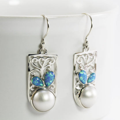 white mabe pearl earrings set in 925 sterling silver decorated with created opal and ornament filigree