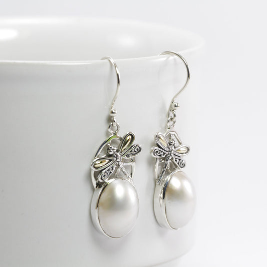 oval pearl earrings set in 925 sterling silver decorated with dragonfly ornament and 18 K gold