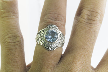 blue topaz ring set in 925 sterling silver decorated with white topaz and ornament filigree