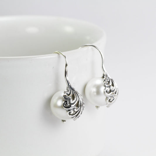 fresh water pearl earrings set in 925 sterling silver decorated with swirl filigree art