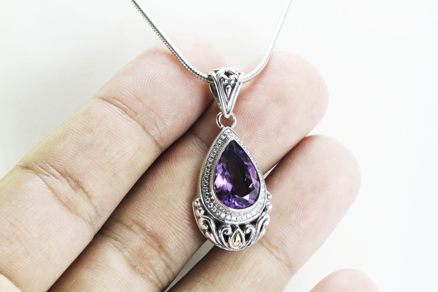 Teardrop amethyst pendant necklace set in 925 sterling silver decorated with 18K yellow gold and white topaz