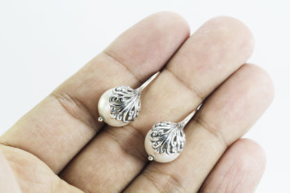 fresh water pearl earrings set in 925 sterling silver decorated with swirl filigree art