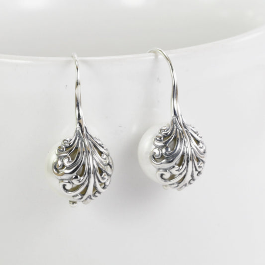 fresh water pearl earrings set in 925 sterling silver decorated with swirl filigree art
