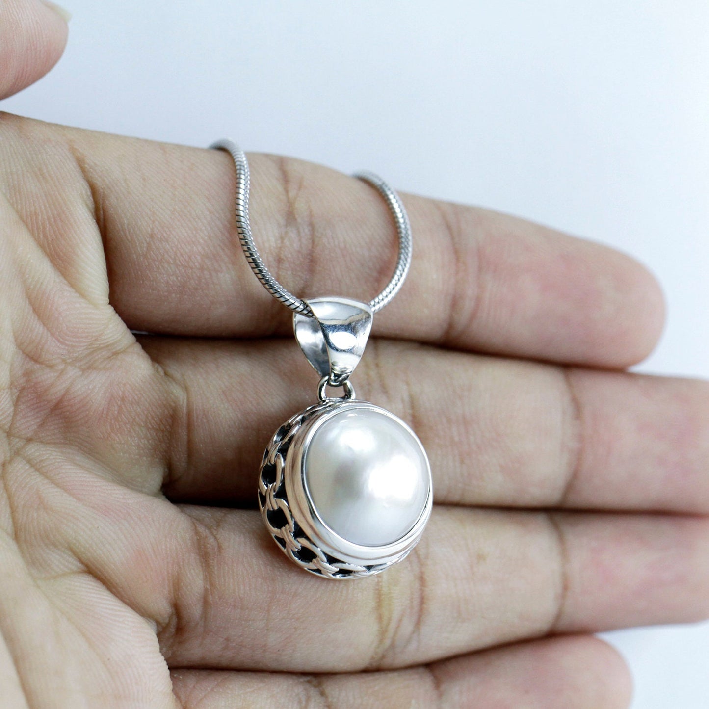 White mabe pearl pendant 13 mm round set in 925 sterling silver decorated with chain carving edge
