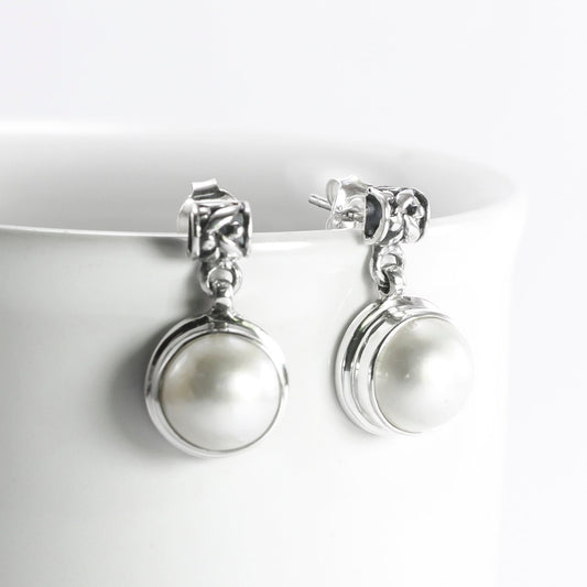 Freshwater Pearl stud earrings set in 925 sterling silver with push back closure decorated with rice bead carving