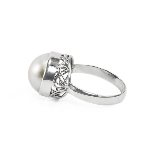 White mabe pearl ring set in 925 sterling silver decorated with swirl filigree