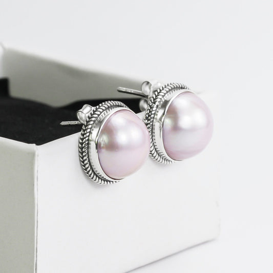 Pink mabe pearl stud earrings set in 925 sterling silver decorated with woven chain edge
