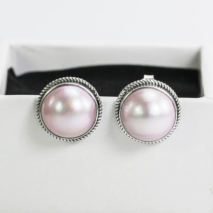 Pink mabe pearl stud earrings set in 925 sterling silver decorated with woven chain edge