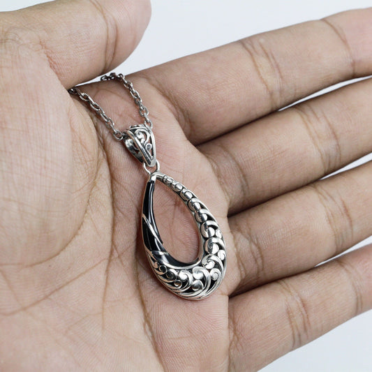Tear drop pendant 925 sterling silver decorated with swirl filigree ornament and natural black shell