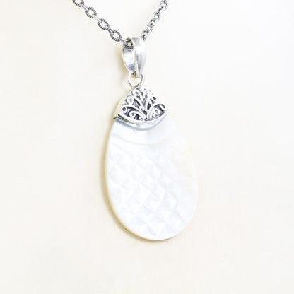 Tear drop pendant with genuine white shell set in 925 sterling silver decorated with Bali swirl filigree ornament