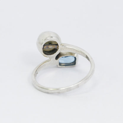 bypass ring with genuine blue topaz and freshwater pearl set in 925 sterling silver