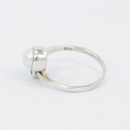bypass ring with genuine blue topaz and freshwater pearl set in 925 sterling silver