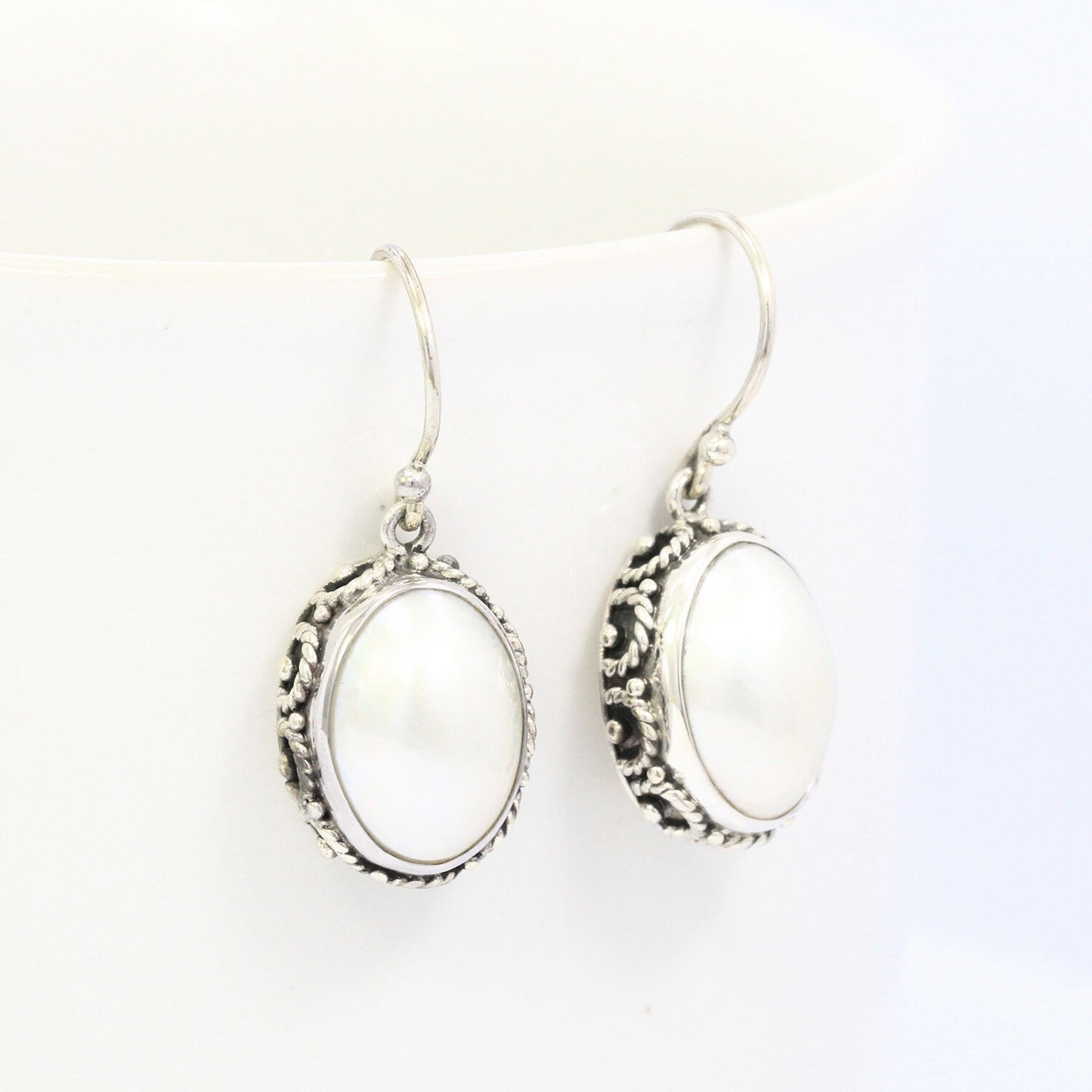 oval white mabe pearl earrings 925 sterling silver decorated with woven ornament bezel